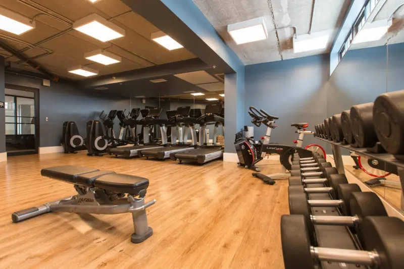 24-hour fitness center with cardio machines and free weights at The Perry Hotel